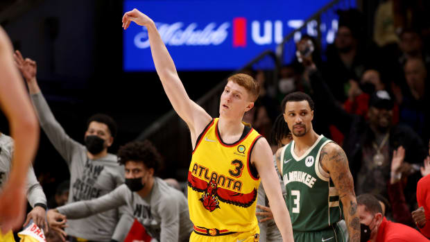 Jan 17, 2022; Atlanta, Georgia, USA; Atlanta Hawks guard Kevin Huerter (3) celebrates a three-point basket during the fourth quarter against the Milwaukee Bucks at State Farm Arena.